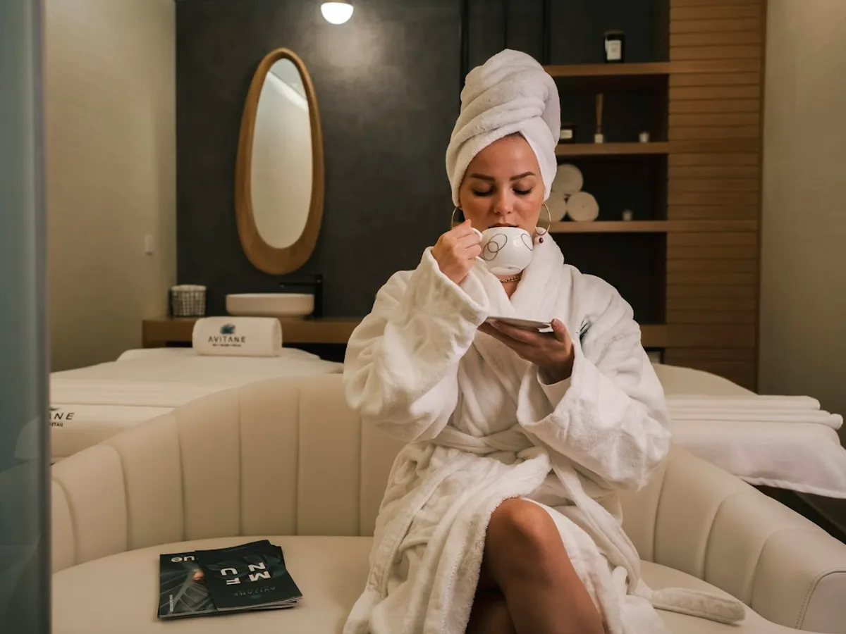 A woman in a robe resting in a treatment room