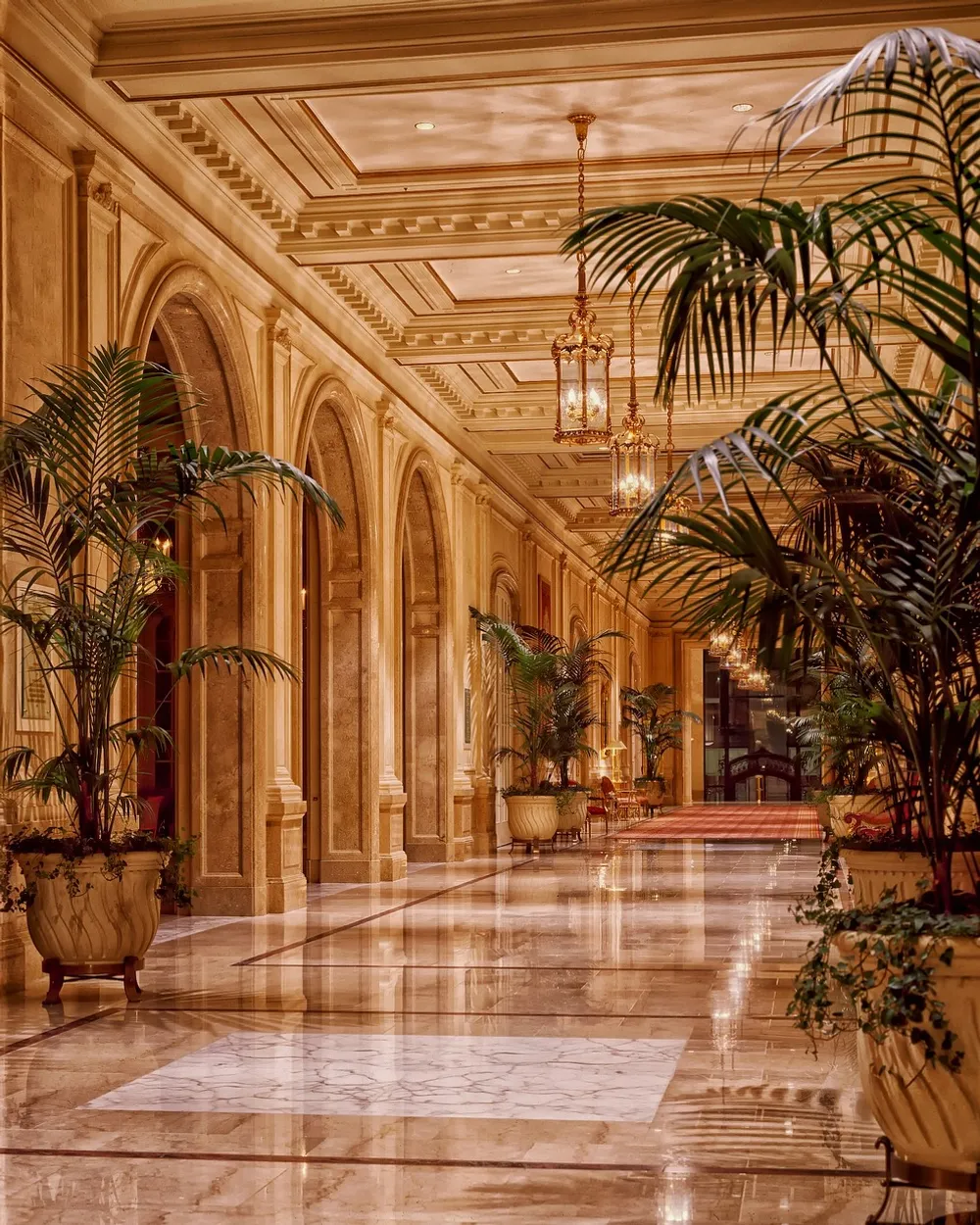 A grand hotel-style lobby with arches and palms