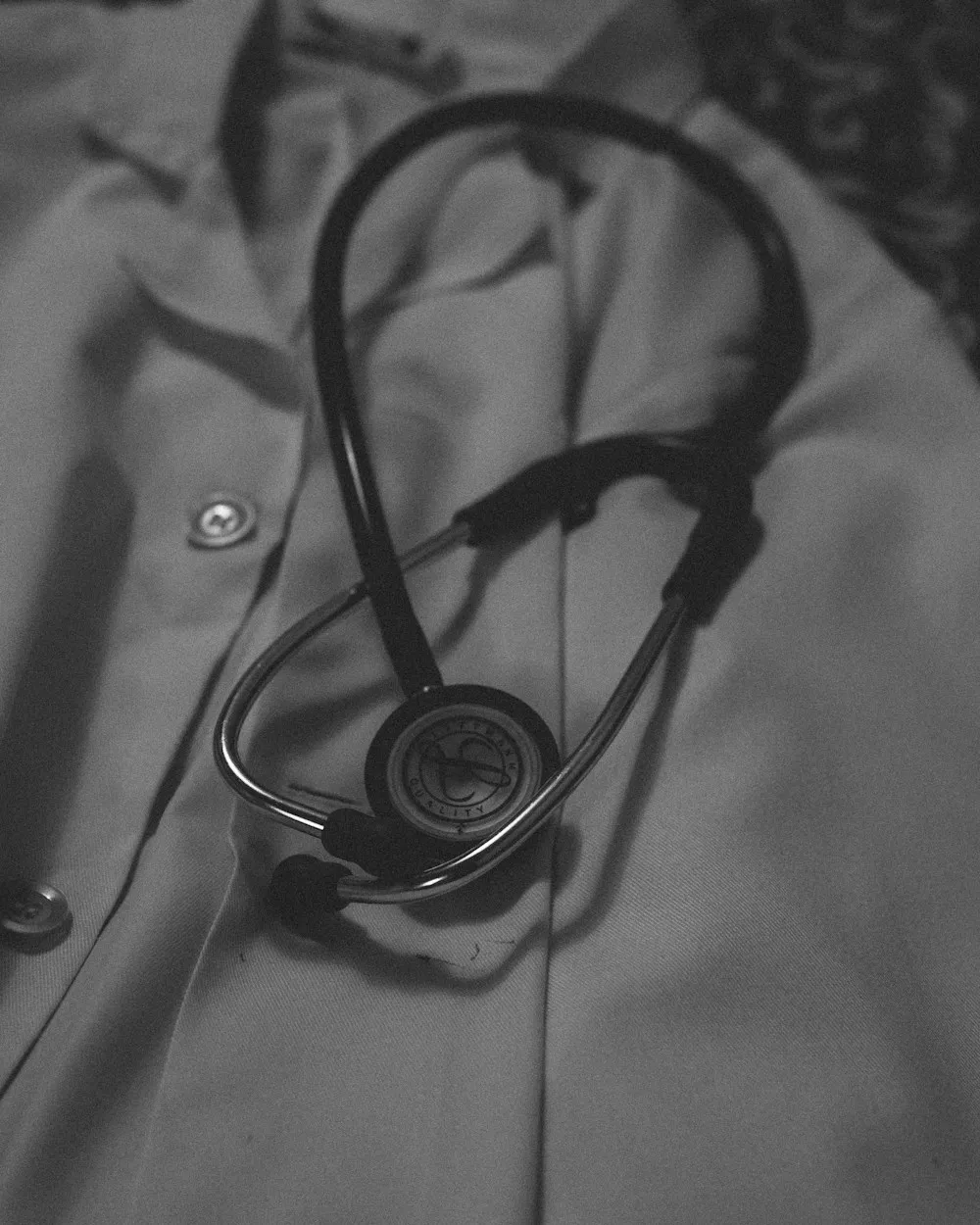 A stethoscope resting on a doctor's coat